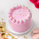 Soft Vanilla Cake - Simple Delights with light pink frosting, white and pink whipped cream swirls, and golden pearls on top. Ideal for same day delivery.