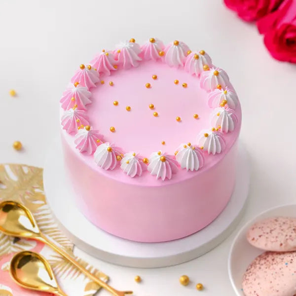 Soft Vanilla Cake - Simple Delights with light pink frosting, white and pink whipped cream swirls, and golden pearls on top. Ideal for same day delivery. Main image