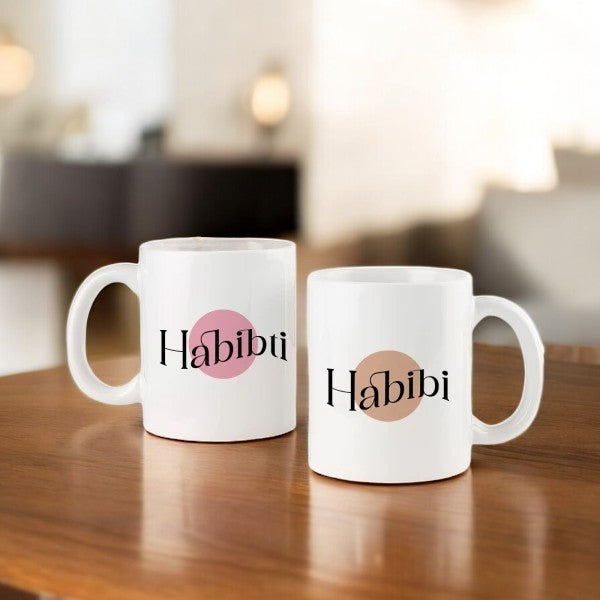 Personalized couple mugs set of 2 with 'Habibi' and 'Habibti' text in pink and beige circles, 350ml ceramic drinkware for couples. Main image