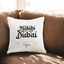 Habibi Dubai Cushion - Personalized with name Uzma on white fabric, placed on a brown sofa. Ideal custom gift for home decor or special occasions.