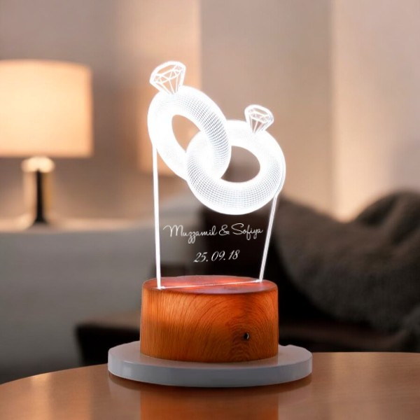 Custom Couple Ring LED Lamp with engraved names and date, featuring a glowing 3D ring design on a wooden base for personalized gifting.
