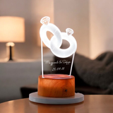 Custom Couple Ring LED Lamp with engraved names and date, featuring a glowing 3D ring design on a wooden base for personalized gifting.