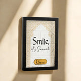 Framed decorative wall art with 'Smile, it's Savannah' text on a beige background