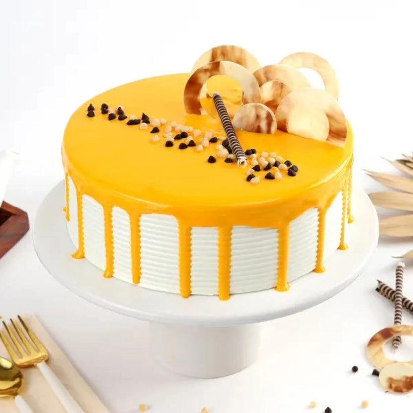 Indulgent Butterscotch Cake - Premium with creamy caramel glaze, chocolate chips, and decorative toppings on a white cake stand. Main image