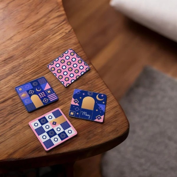 Set of 4 Custom Coasters with bold patterns and personalized name, great for adding style to tables in home or office settings.