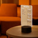 Customizable TaskMate LED Lamp glowing on a desk, perfect for home office lighting and personalized workspace decor.