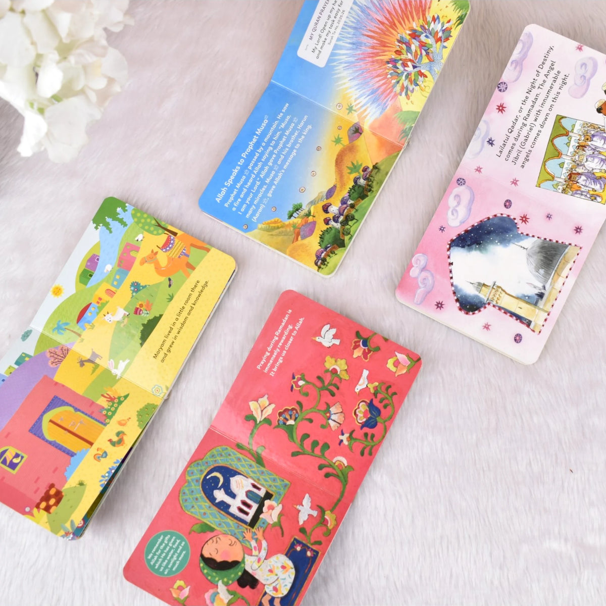 Open pages of 4 board books from the Ramadan and Eid Gift Box showing vibrant illustrations and Islamic stories for toddlers and young kids.