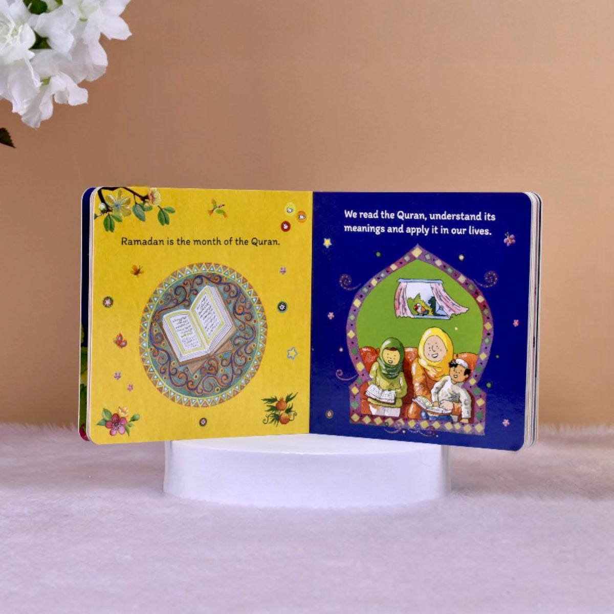Inside pages of Ramadan Mubarak Board Book showing Quran teachings and family reading, perfect for introducing Islamic values to children.