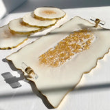 Decorative white plate with gold embellishments on a light gray background