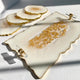 Decorative white plate with gold embellishments on a light gray background