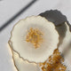 Decorative ceramic plate with gold center on a white background