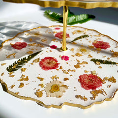 Bottom tier of Floral 3 Tier Serving Stand adorned with real flowers and gold accents, perfect for housewarming or personalized gifts.