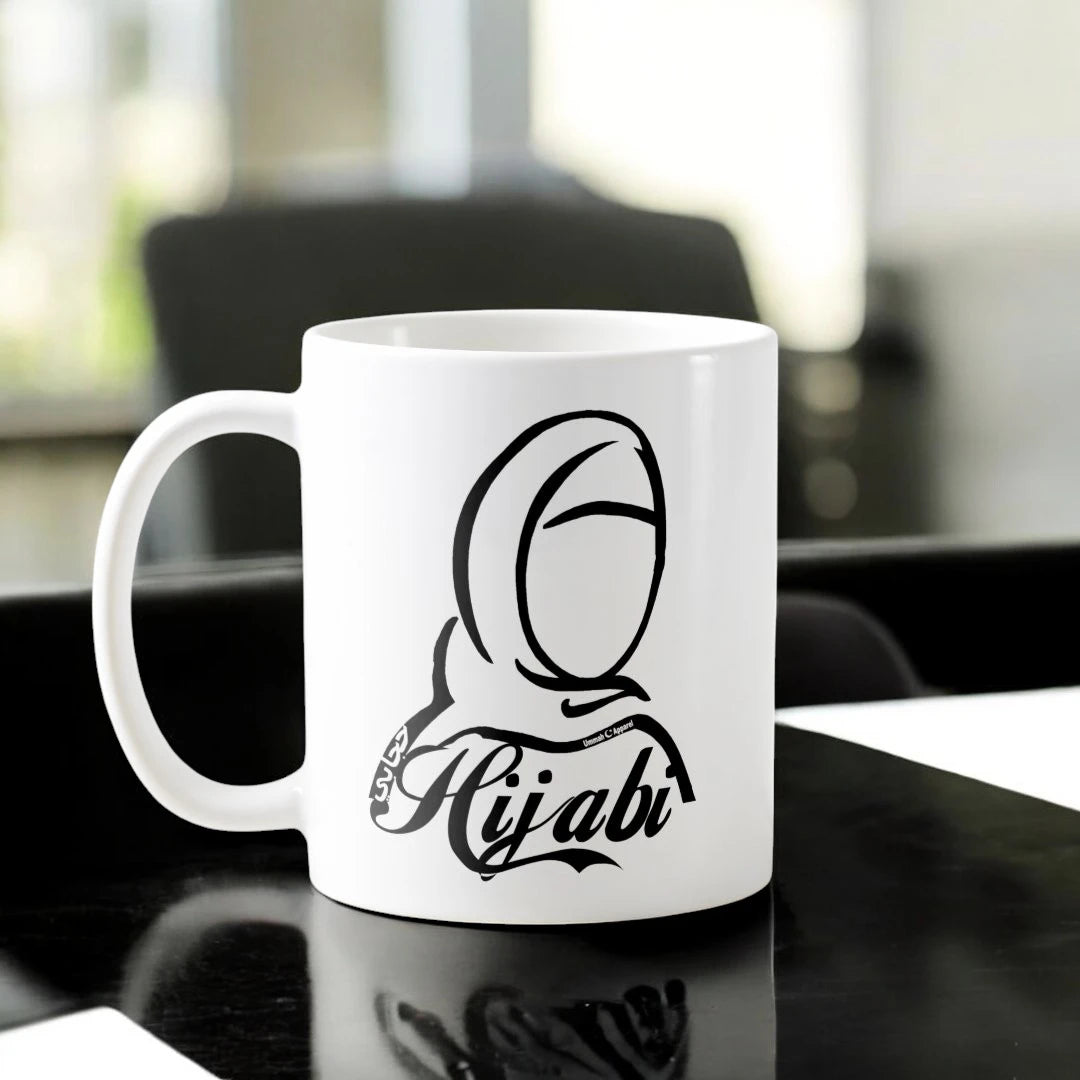 Hijabi Mug Ceramic featuring minimalist hijab illustration and 'Hijabi' text, symbolizing identity and strength. 350ml, microwave-safe drinkware. Main image