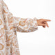 Close-up of Prayer Dress 11 sleeve with elastic cuff and detailed beige leaf print on chiffon, combining comfort and elegance.