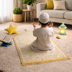 White Kids Dome Janamaz - Kids Dome Prayer Rug shown in a cozy living room with a child praying, ideal for ages 3 to 10. Soft, foldable, and portable.