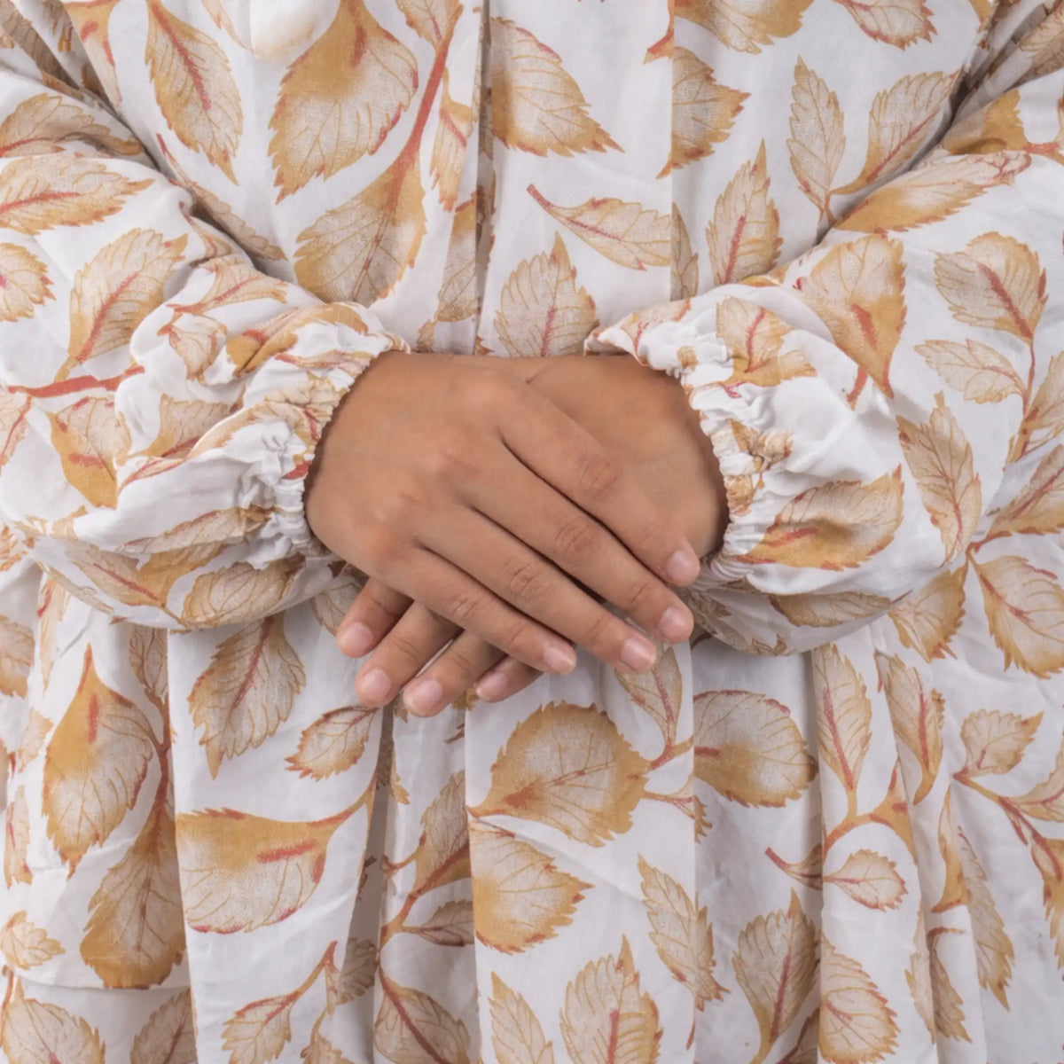 Detailed view of Prayer Dress 11's gathered sleeves and soft chiffon fabric with autumn leaf design, perfect for prayer and modest wear.