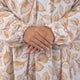 Detailed view of Prayer Dress 11's gathered sleeves and soft chiffon fabric with autumn leaf design, perfect for prayer and modest wear.